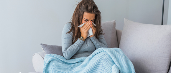 Woman-Suffering-from-Viral-Infection-Blowing-Running-Nose-in-a-Tissue-Paper