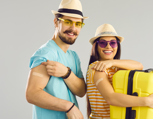 Man-and-woman-happy-to-showing-bandages-after-travel-vaccine